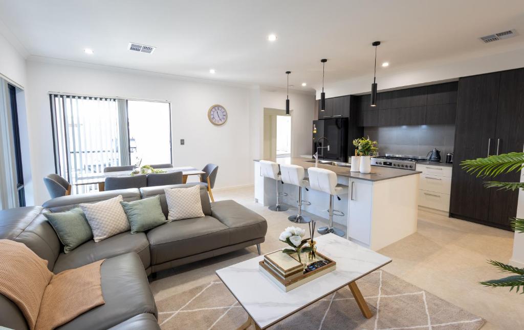 a living room with a couch and a kitchen at Shipwreck Park Villas in Westfield