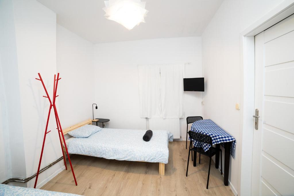 a room with two beds and a table and chairs at Hostel Jamnik in Psary
