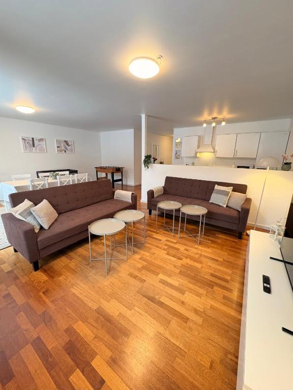 a living room with a couch and tables at K&V Apartments Billund Near Legoland #1 in Billund