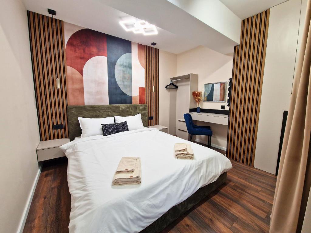 a bedroom with a bed and a desk in it at By The Pool Apartments #7 in Velingrad