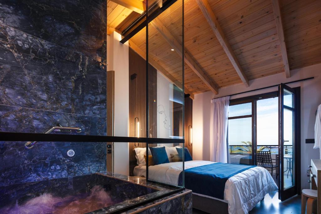 a bedroom with a bed and a tub in a room at My Luxury Downtown Vibe Suites in Rethymno