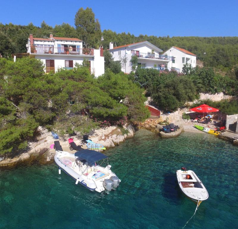 two boats are docked in a body of water at Apartments Villa Hraste Hvar in Hvar