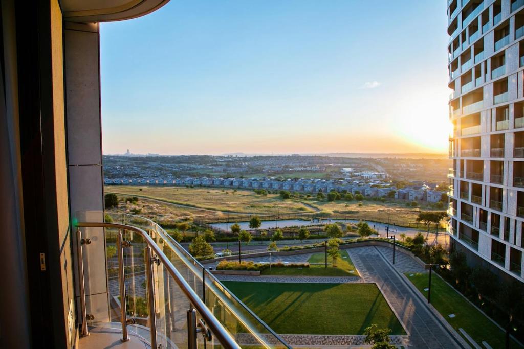 a view of a city from a balcony of a building at Ad Astra Studio Apartment - Waterfall in Midrand