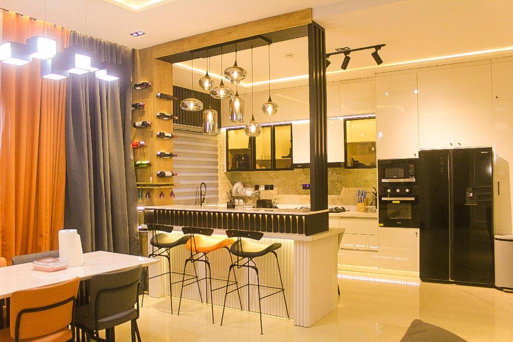 a kitchen with a black refrigerator and bar stools at Dalos Unit in Ilado