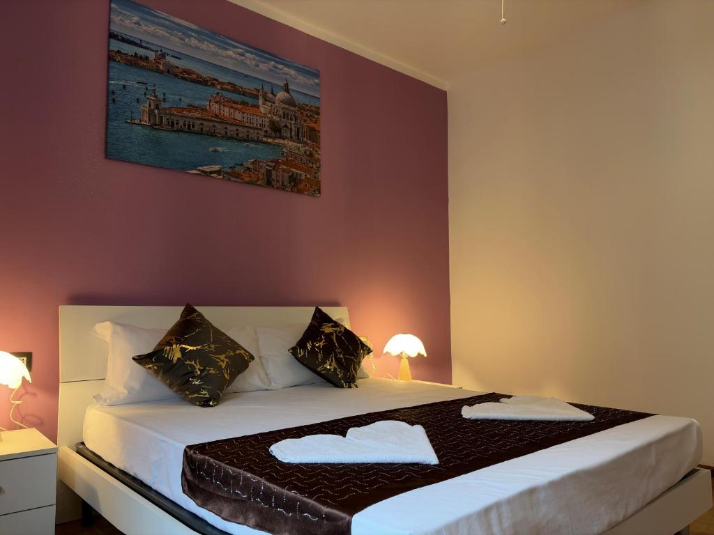 a bedroom with a large bed with two pillows at CA'venezia in Mestre