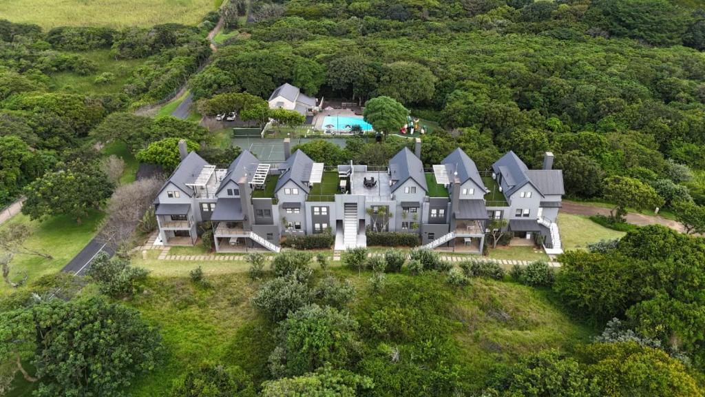 an aerial view of a large house on a hill at Apartments on The Eighteenth at Prince's Grant Golf Estate in Blythedale