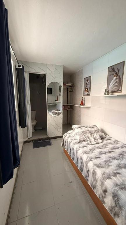 a bedroom with a bed and a mirror in it at Alure 1 in Belo Horizonte