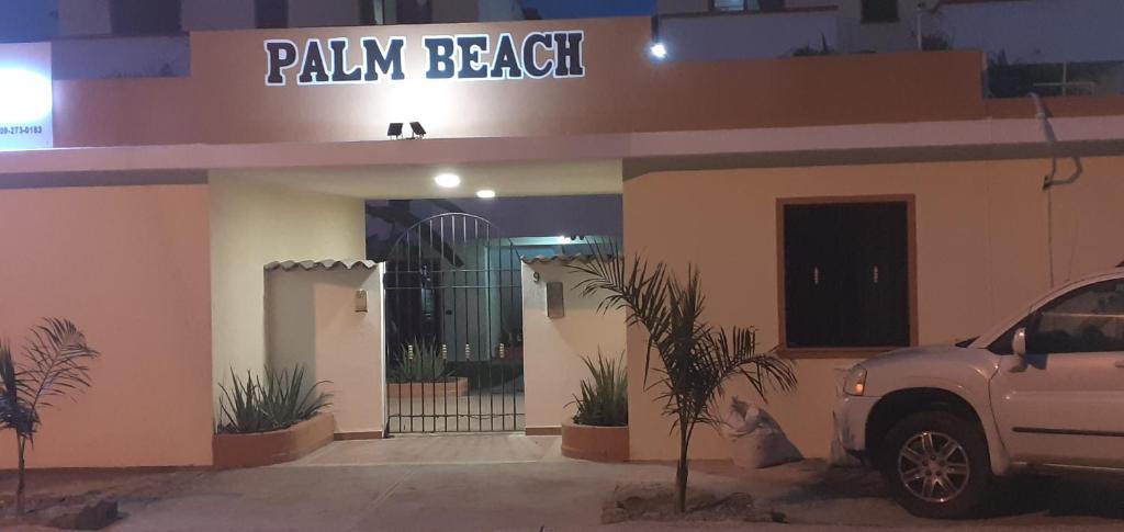 a white truck parked in front of a building at Palm Beach Resort in Boca Chica