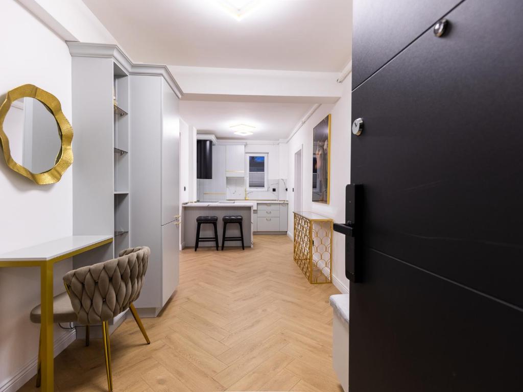 a kitchen and living room with a black door at Nubia Central Apartments in Bistriţa