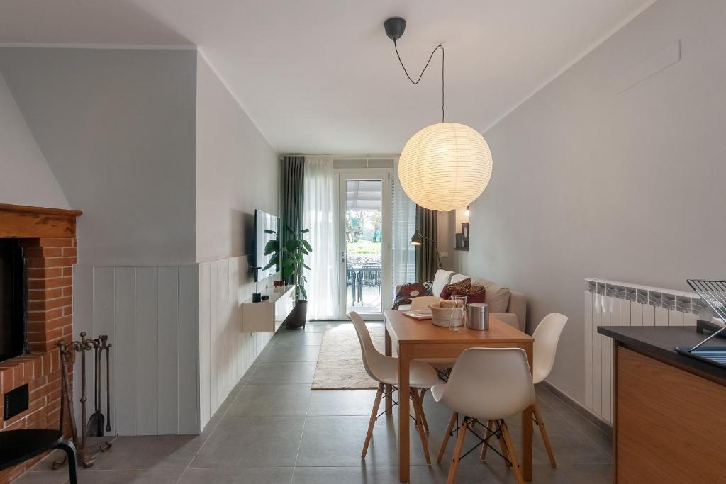 a kitchen and dining room with a table and chairs at Blueyes House Tuscany in Artimino
