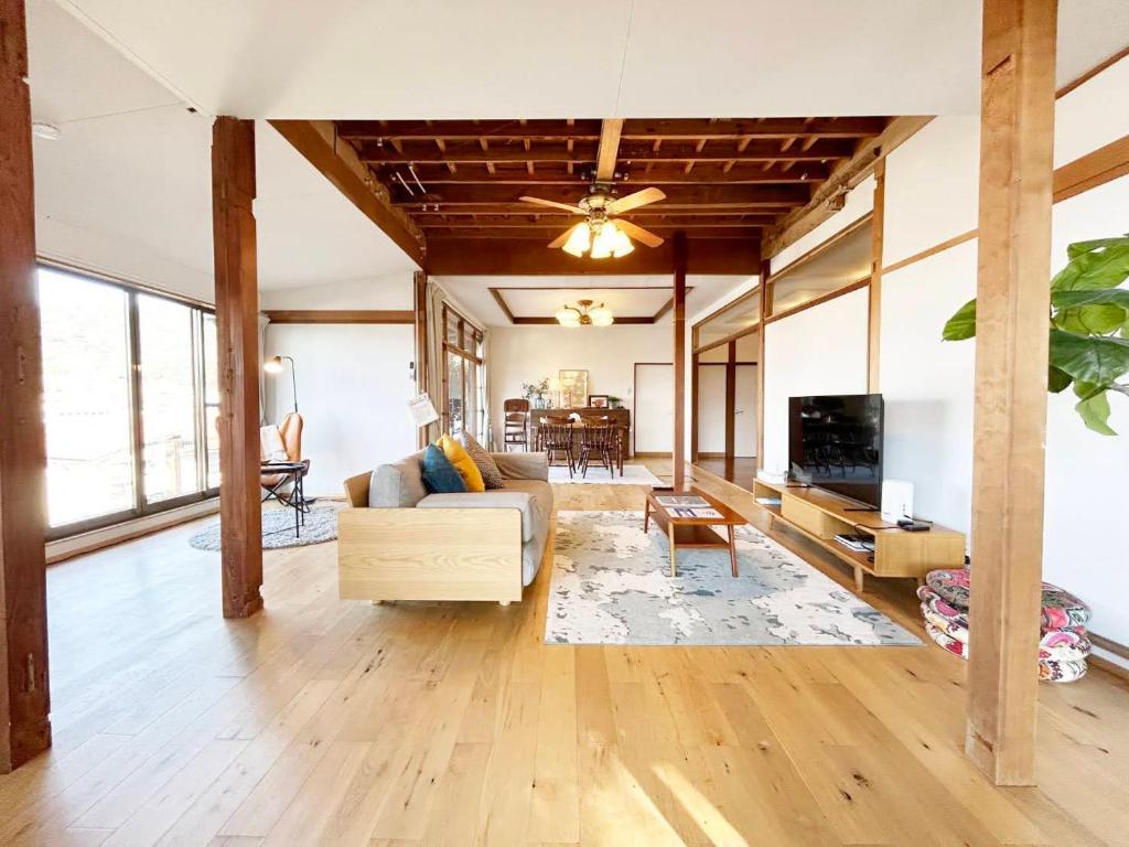 a living room with a couch and a tv at 太宰府らたん - Dazaifu Ratan in Dazaifu