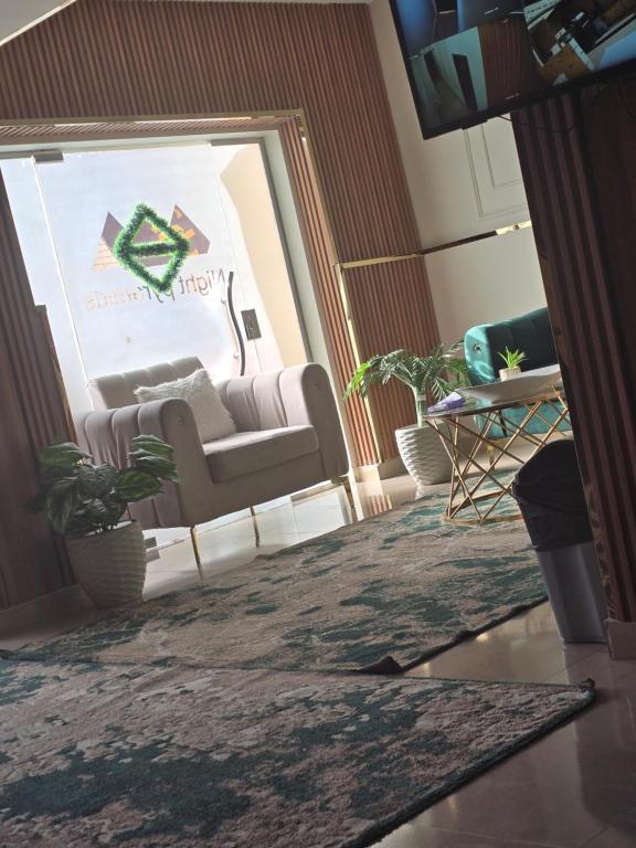 a living room with a couch and a table at Break pyramids inn in Al Manşūrīyah