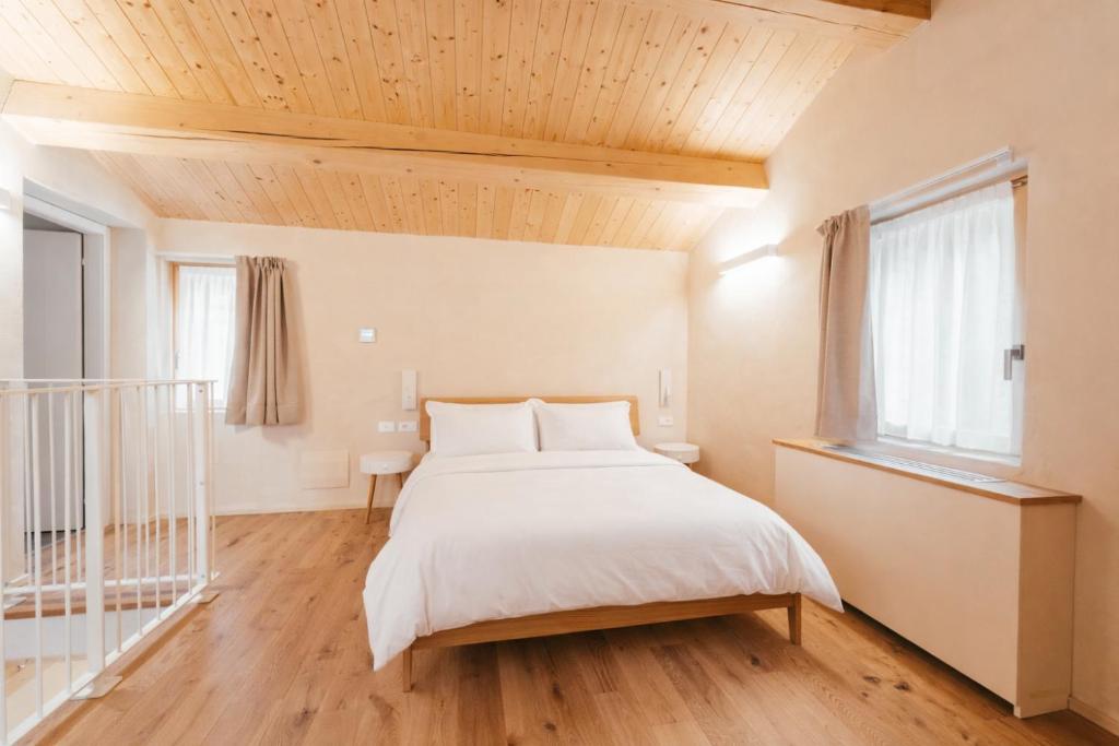 a bedroom with a bed and a wooden ceiling at Locanda dell'Ortolano in Ferrara