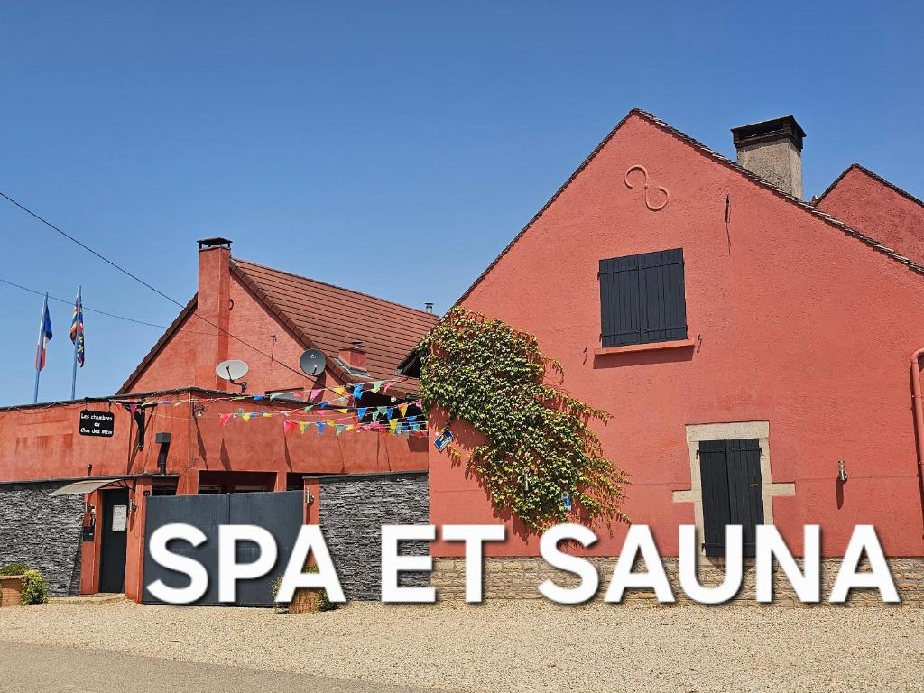 a red building with a sign in front of it at Le Clos des Meix in Lanthes