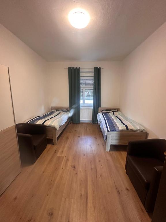 a living room with two beds and a couch at Monteurunterkunft nahe Tor 1 in Leuna