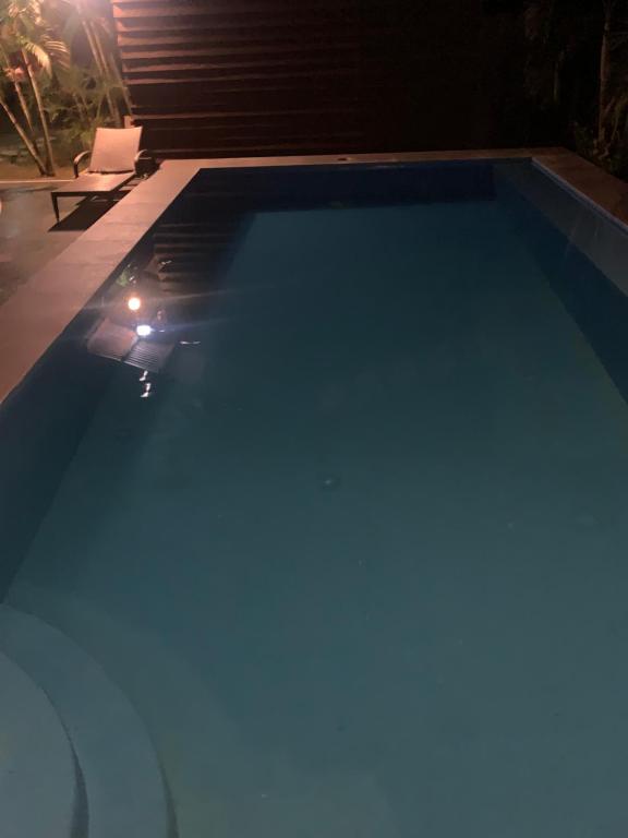 a swimming pool at night with a light in it at Terreza's Place in Panglao Island