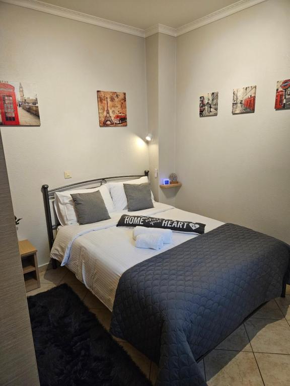 a bedroom with two beds and pictures on the wall at B&M Cozy Corner in Igoumenitsa