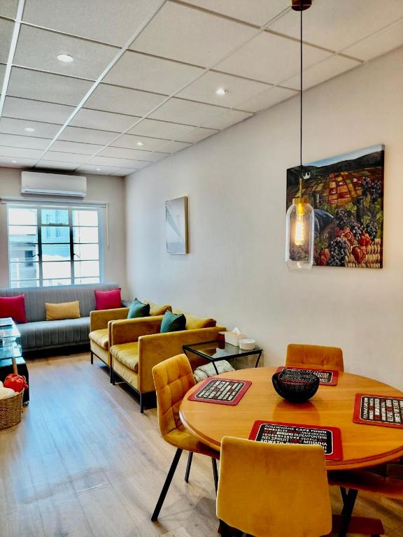 a living room with a table and a couch at Pepper Korrel - Paarl - Self Catering Apartment in Paarl