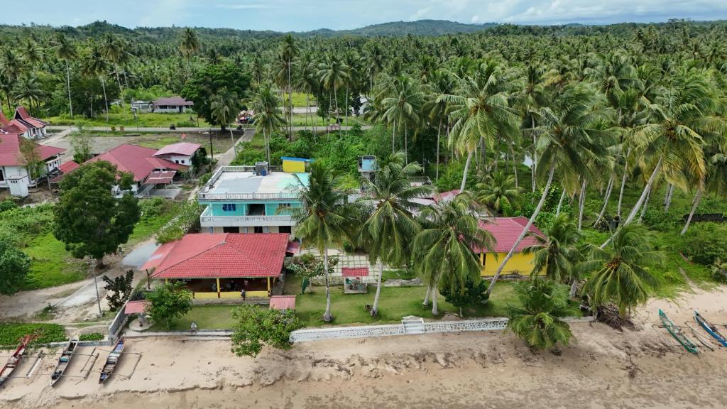 an aerial view of a resort with palm trees at Harus Damai Inn in Lagudri