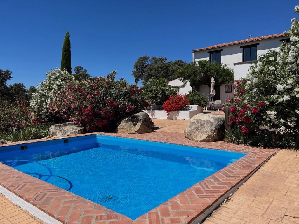 a swimming pool in the yard of a house at Cortijo Majada de las Vacas in Santa Olalla del Cala