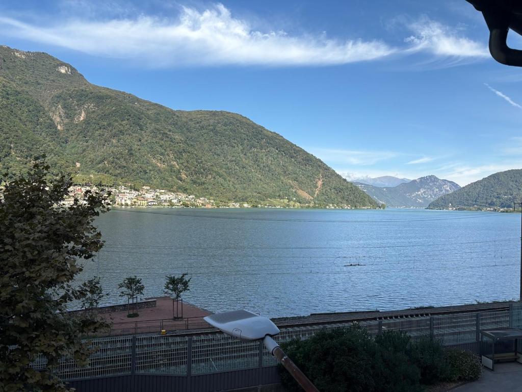 a view of a large body of water with mountains at the Lake View apartment in Mendrisio