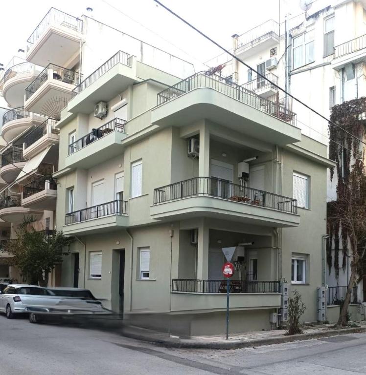 a building with balconies and a stop sign in front of it at City Keys Volos in Volos