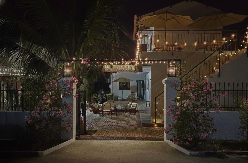a building with a courtyard at night with lights at Nhà Vườn - Garden homes in Ấp Bến Ké (2)