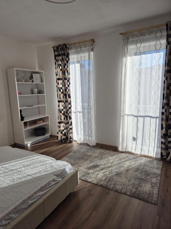 a bedroom with a bed and a large window at Dein Zuhause am See in Millstatt