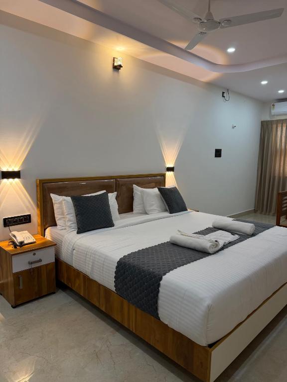 a bedroom with two beds with pillows at HOTEL FORTUNER Inn in Bangalore