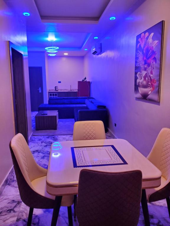 a room with a table and chairs and a bed at Romeo Apartment in Ipaja