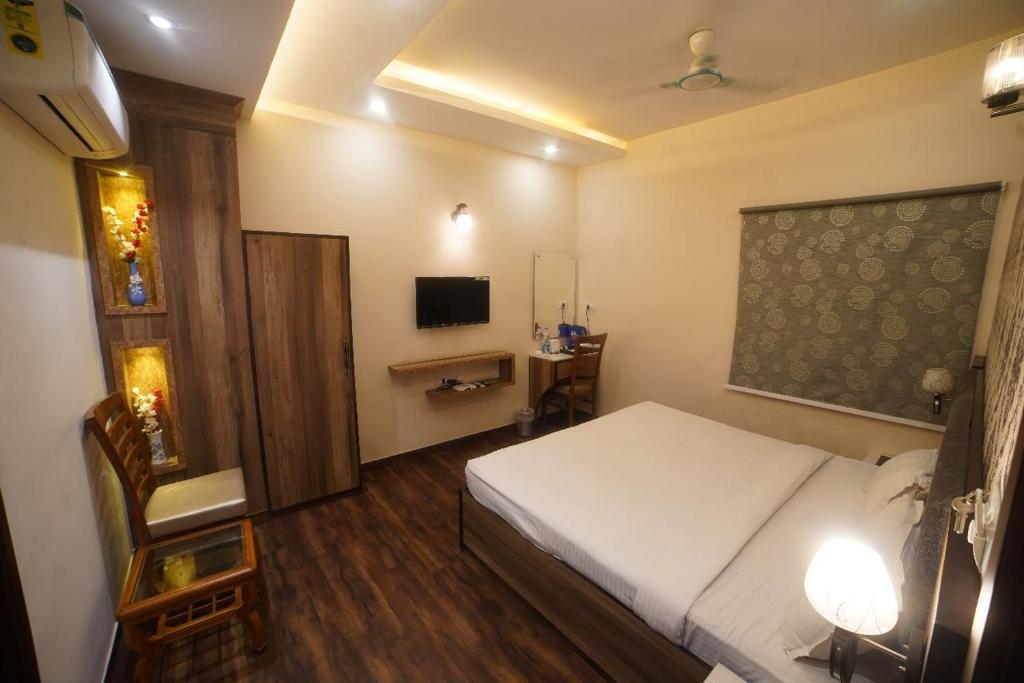 a bedroom with a bed and a chair and a desk at Hotel P1 The Comfort Zone in Jalandhar