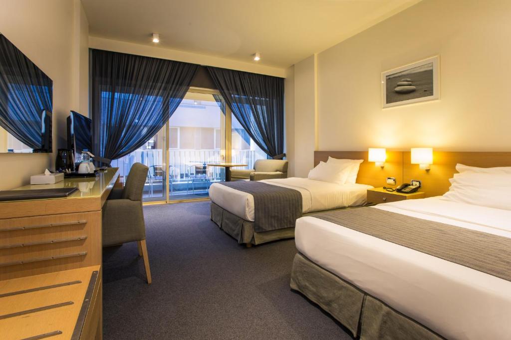 Postel nebo postele na pokoji v ubytování Hotel Cavalier