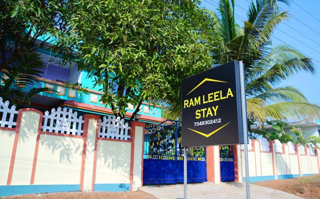 a sign in front of a building with a palm tree at Ramleela Stay, Gokarna in Ankola