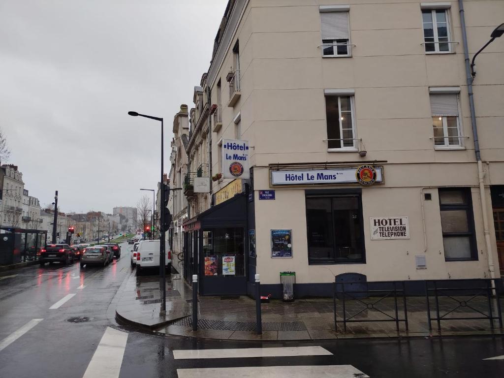 a building on a city street in the rain at Hôtel Du Mans in Angers