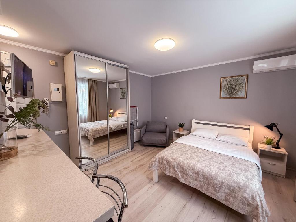 a small bedroom with a bed and a mirror at Kyiv Lesi 3 Studio Apartment in Kyiv