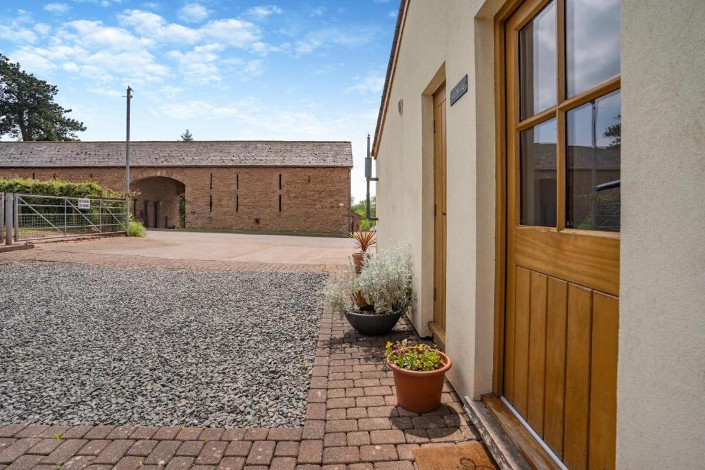 a door to a building with potted plants next to it at 4 Bed in Wonastow oc-k29425 in Wonastow