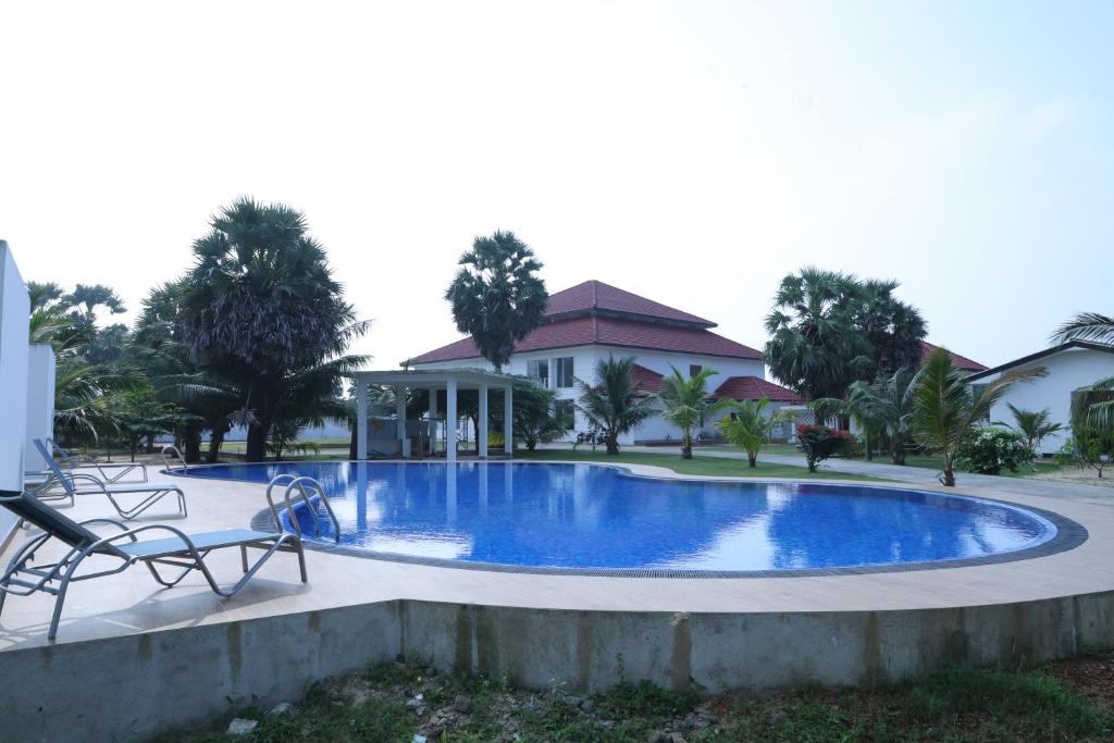 a swimming pool in a villa with a house at Palmyra resort in Jaffna