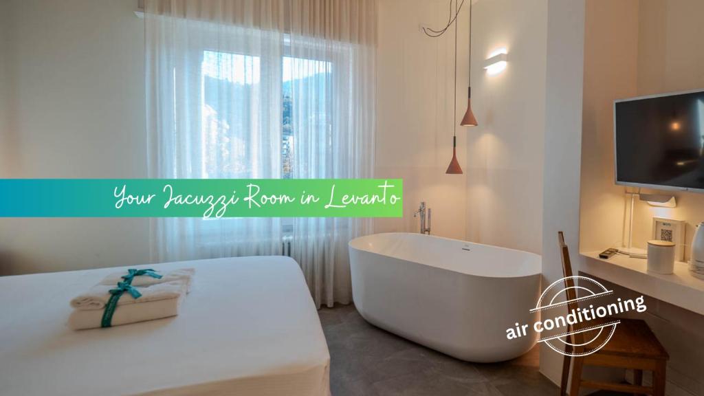 a bathroom with a bath tub and a television at Isabella Boutique Rooms in Levanto