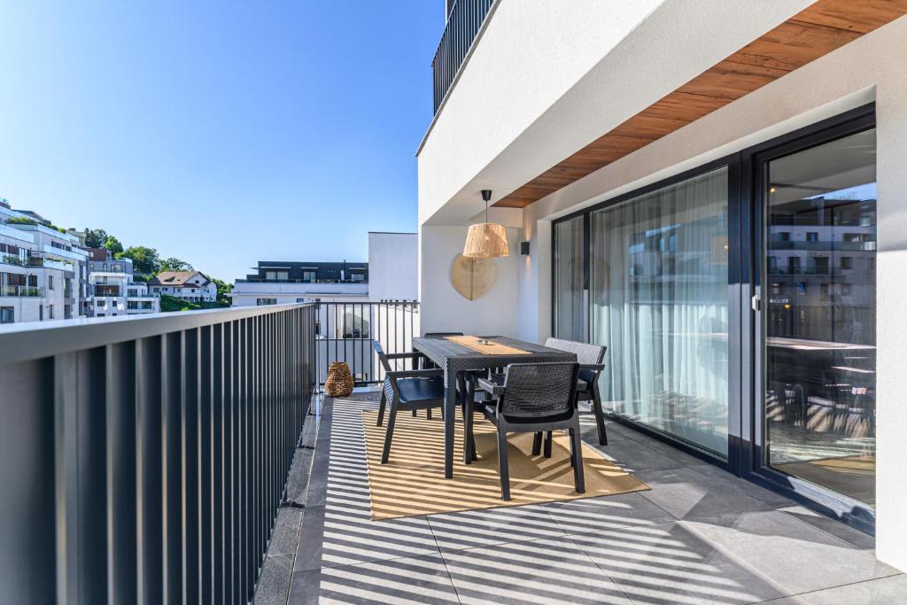 a patio with a table and chairs on a balcony at KOA - Signature Collection in Braşov