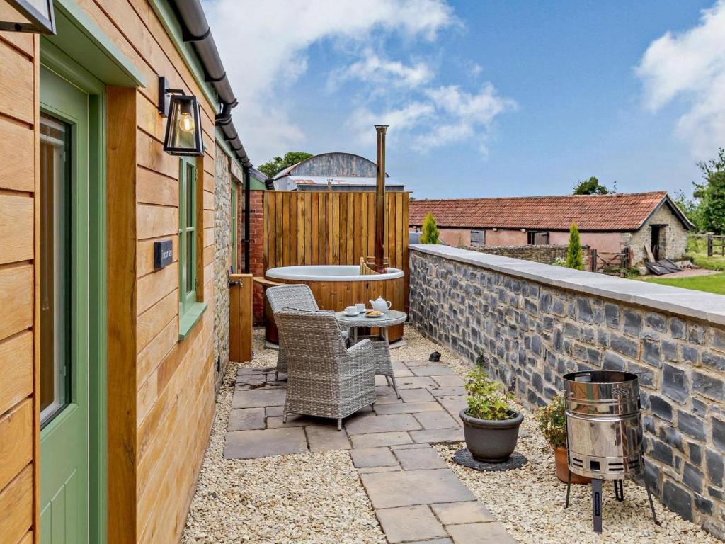 a patio with a table and chairs and a fence at 1 Bed in Taunton oc-80693 in North Curry