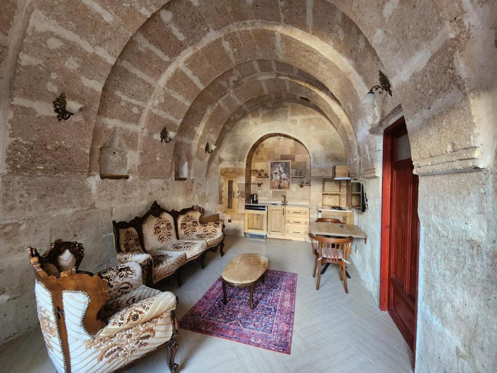 a room with couches and a table in a building at Key of Cappadocia - House of Beautiful Horses in Avanos