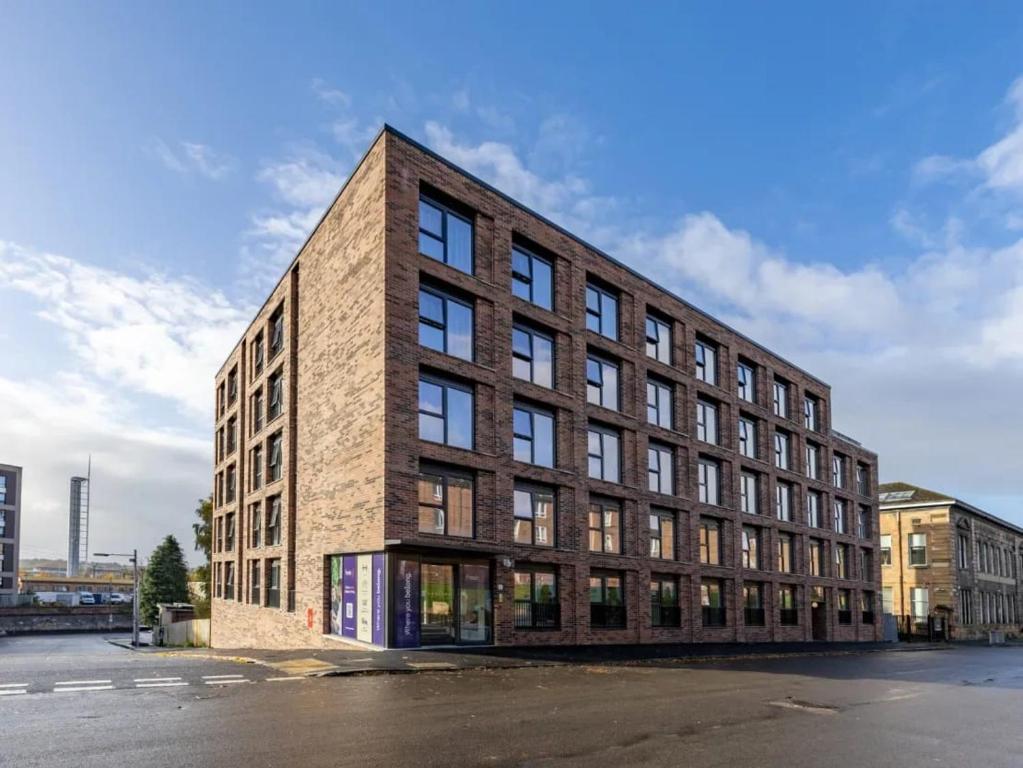 a brick building with windows on the side of a street at For Students Only West End in Glasgow in Glasgow