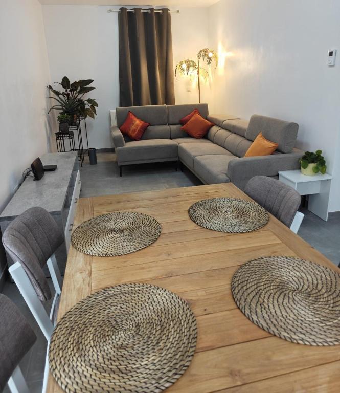 a living room with a table and a couch at Au pays des cigognes in Cambron-Casteau