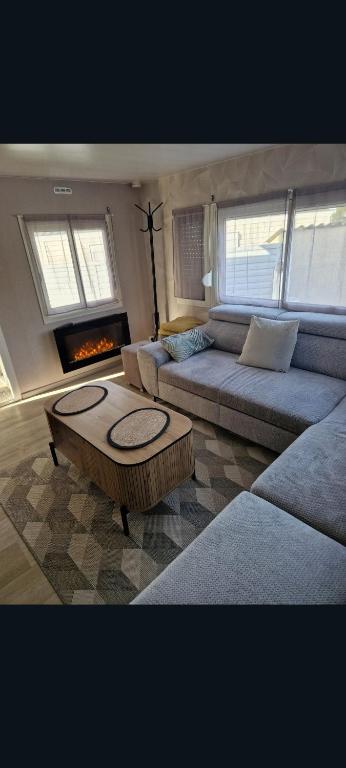 a living room with a couch and a coffee table at Mobilhome spacieux in Pornic