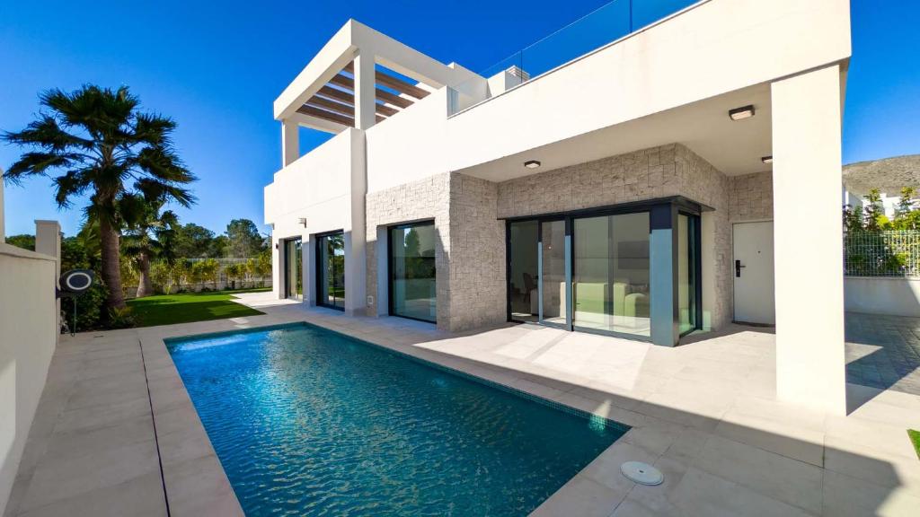 a house with a swimming pool in front of it at Villa Horizonte in Finestrat