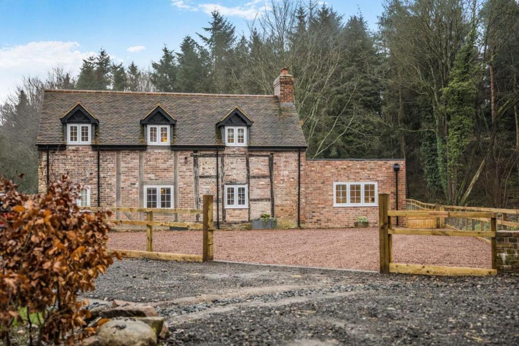 an old brick house with a wooden fence at 3 Bed in Callaughton oc-b34809 in Much Wenlock