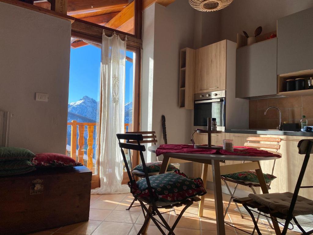 a kitchen with a table and chairs and a window at Beautiful chalet accommodation with covered parking in Cianfuran