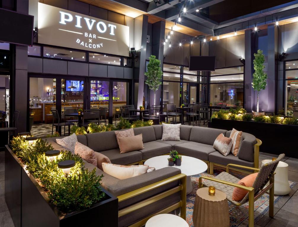 a lobby of a restaurant with couches and tables at Hyatt House Indianapolis Downtown in Indianapolis