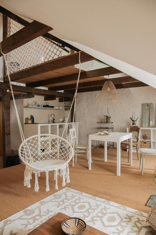 a living room with a swing and a table at Flusshaus BnB Alicudi in Brugg
