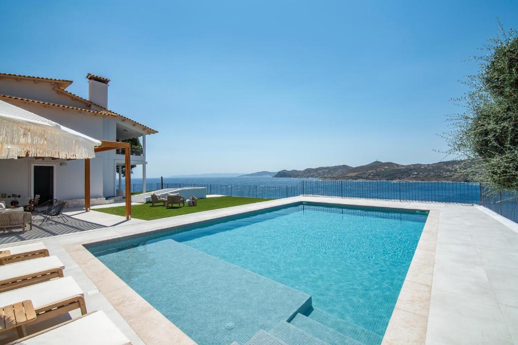 a swimming pool with a view of the ocean at Villa Consta with Tennis, Saltwater Pool & Sea Views by KB Hospitality in Dhaskalión